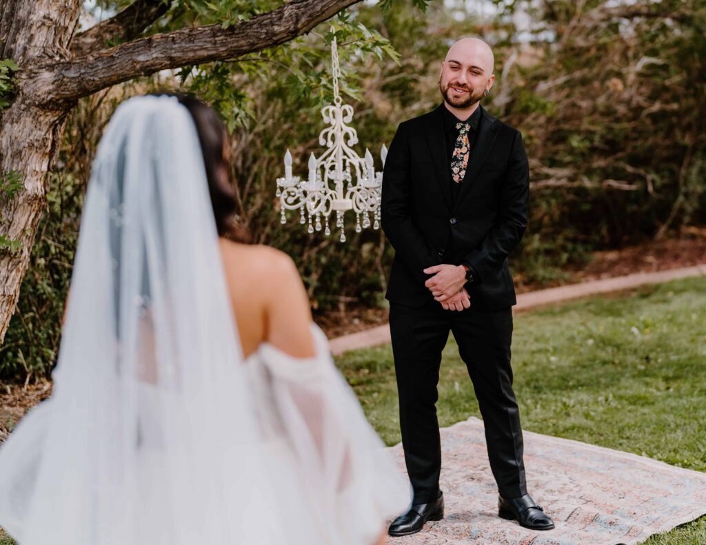 Bride and groom share an emotional first look before their wedding