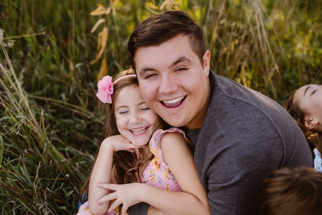 brother and sister smile and laugh together