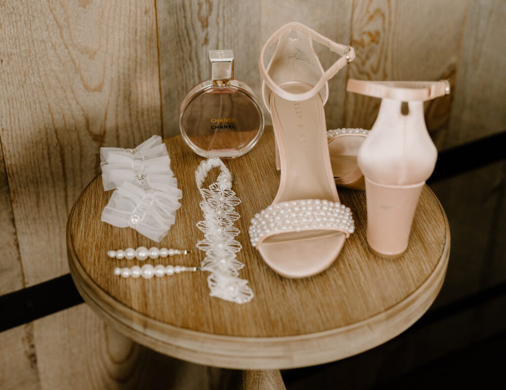 bride putting on earrings while her mom smiles and laughs with her