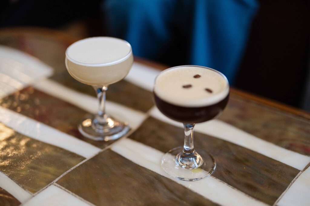 Two cocktails on a striped table inside Union Station.